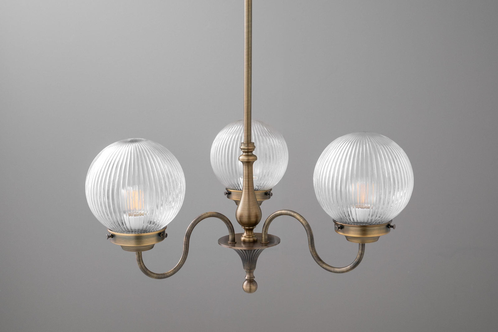 Antique brass chandelier with three ribbed glass globe shades and curved arms. - CHANDELIER MODEL NO. 2894