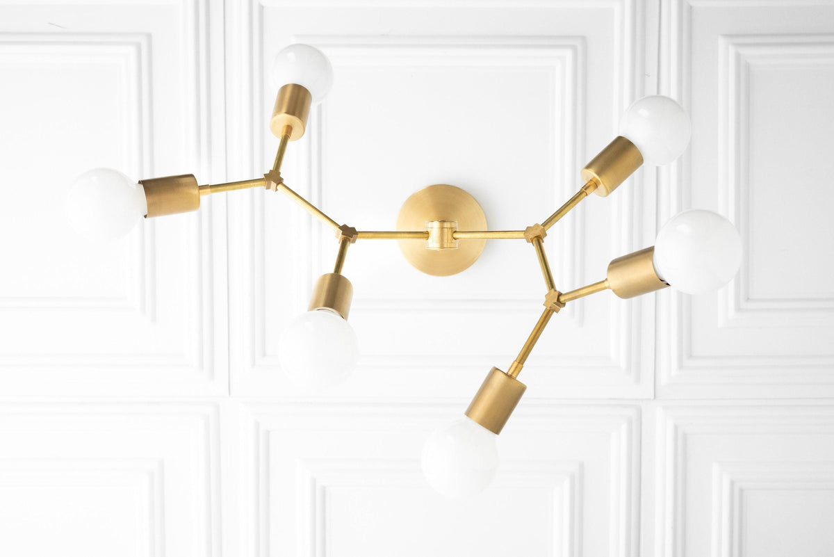 Raw brass Art Deco chandelier with six exposed bulbs and angular arms mounted on round wall plate. - CHANDELIER MODEL NO. 2523
