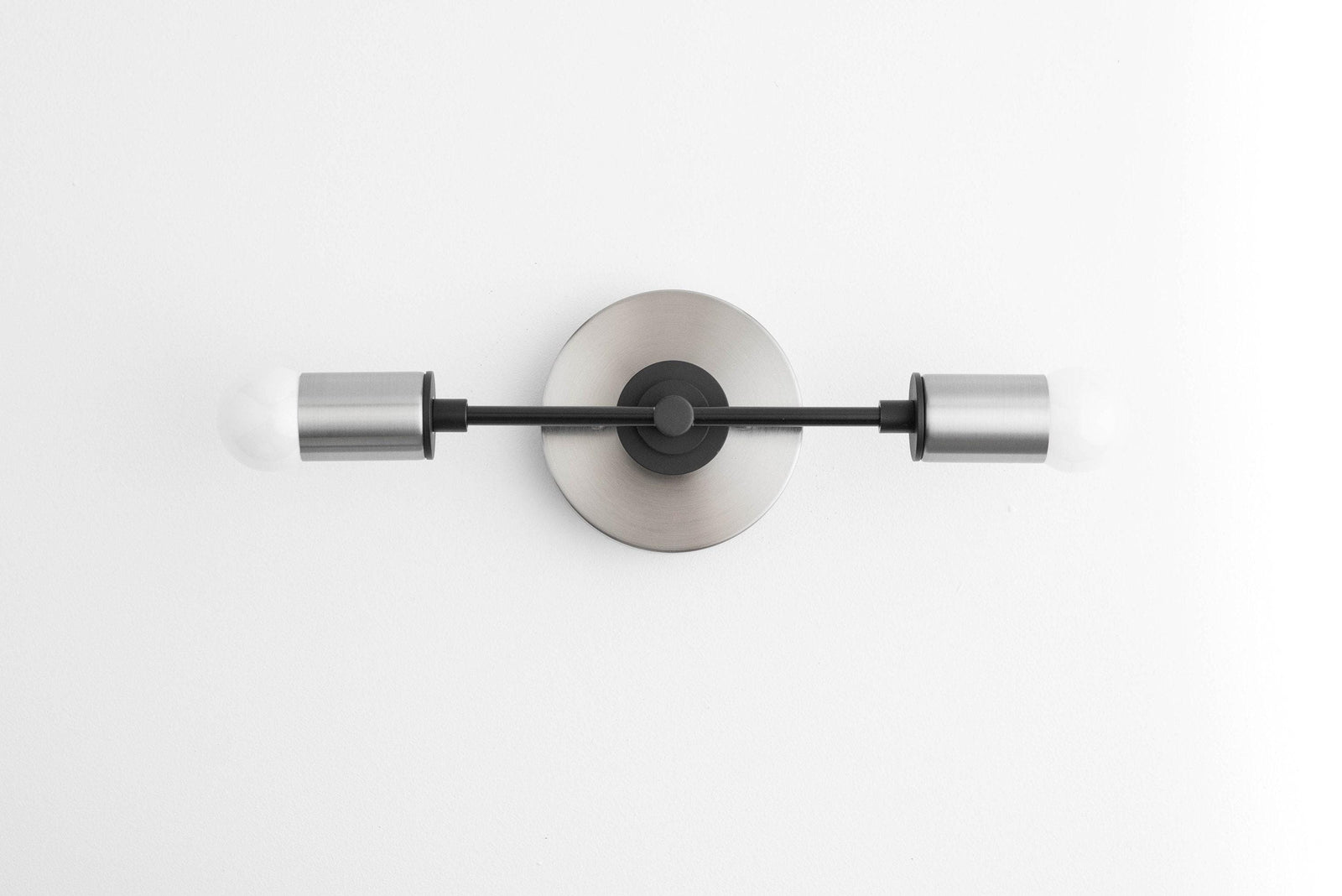 Brushed Nickel and Black Art Deco vanity light with two cylindrical shades and circular wall mount. - VANITY LIGHT MODEL NO. 8057
