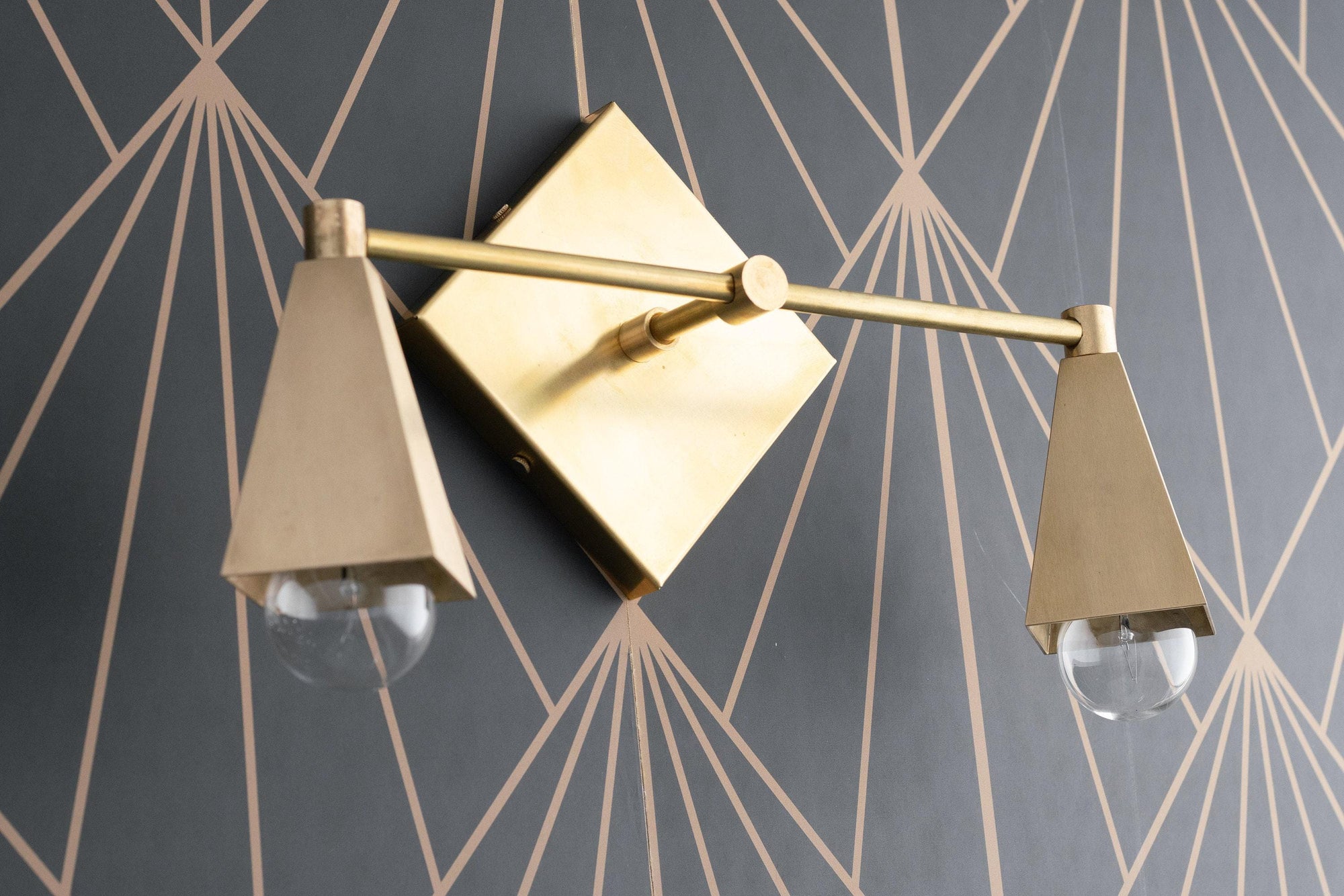 Art Deco style two-bulb vanity light in raw brass with conical shades and clear bulbs. - VANITY LIGHT MODEL NO. 4237