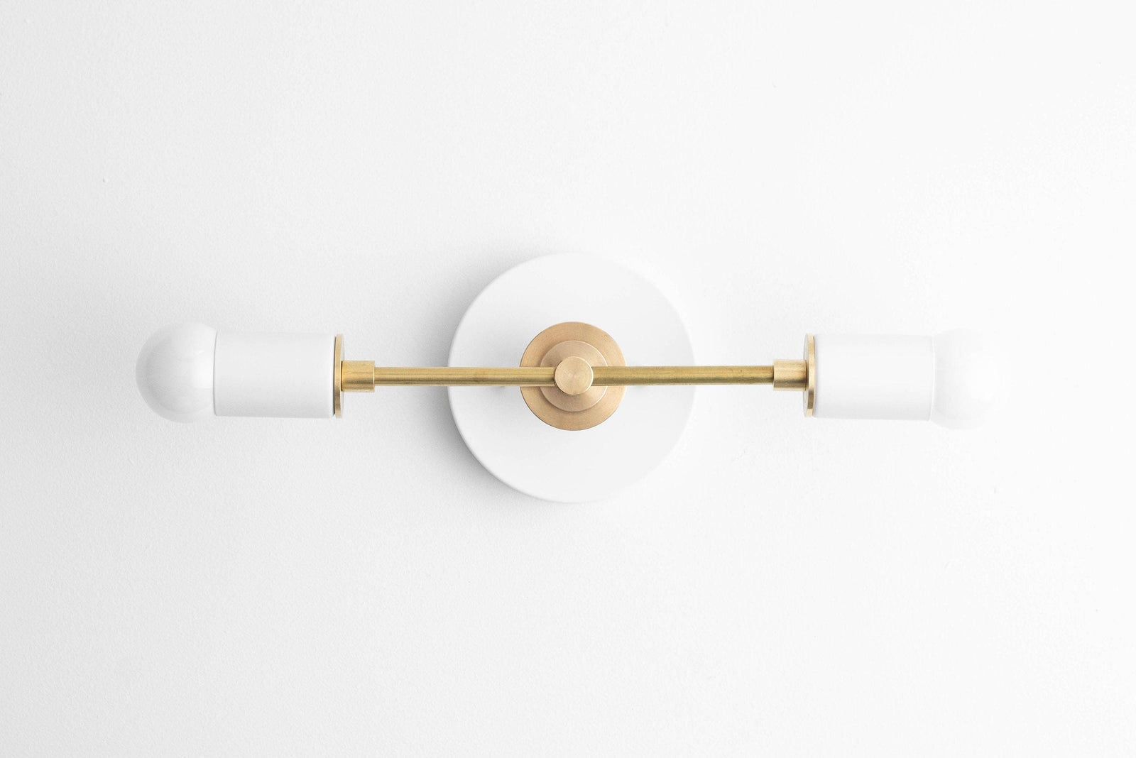 Art Deco vanity light with a polished brass center and two frosted white glass globes on either end. - VANITY LIGHT MODEL NO. 8057
