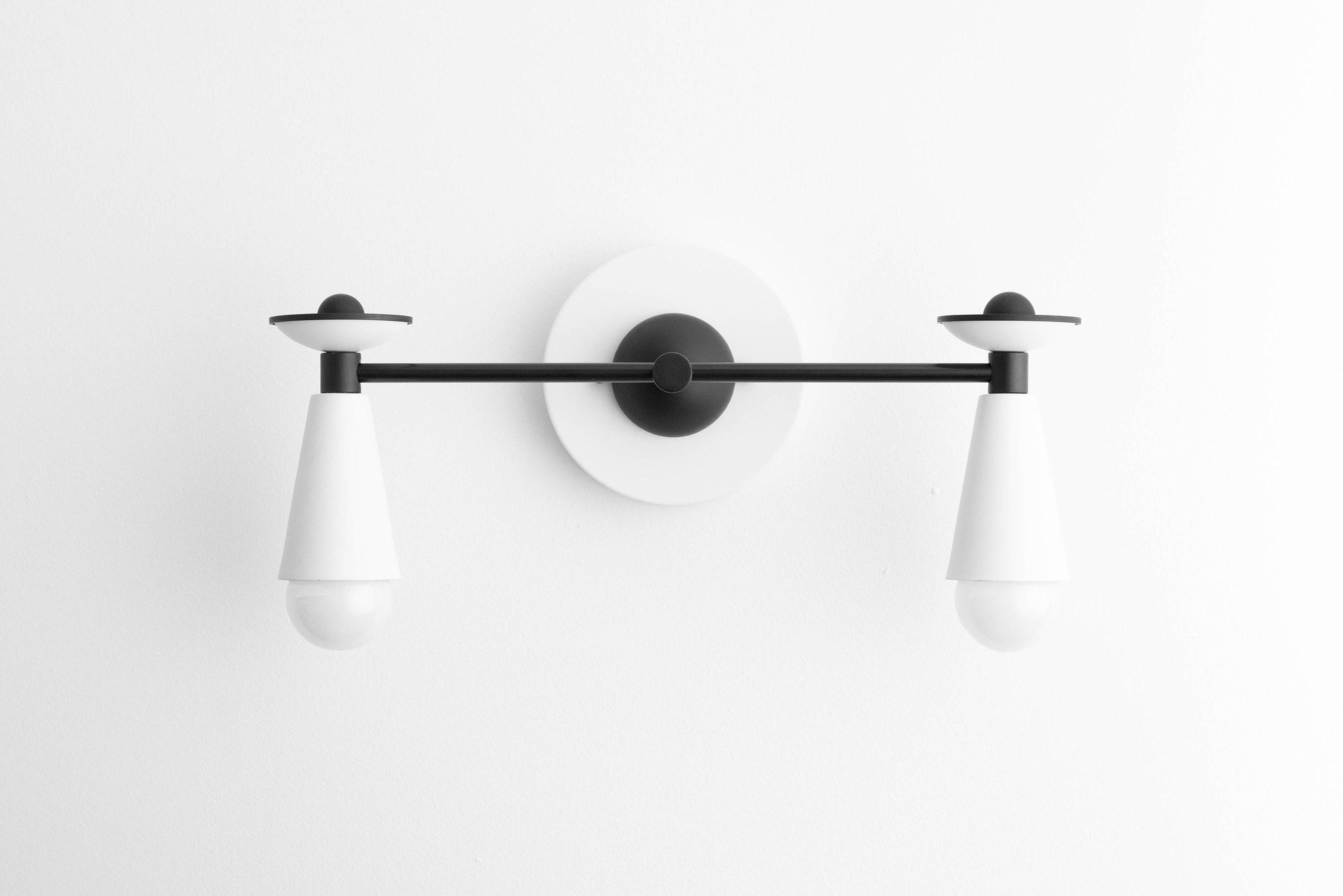 Art Deco style black and white 2-bulb vanity light with conical shades and round wall mount. - VANITY LIGHT MODEL NO. 4517