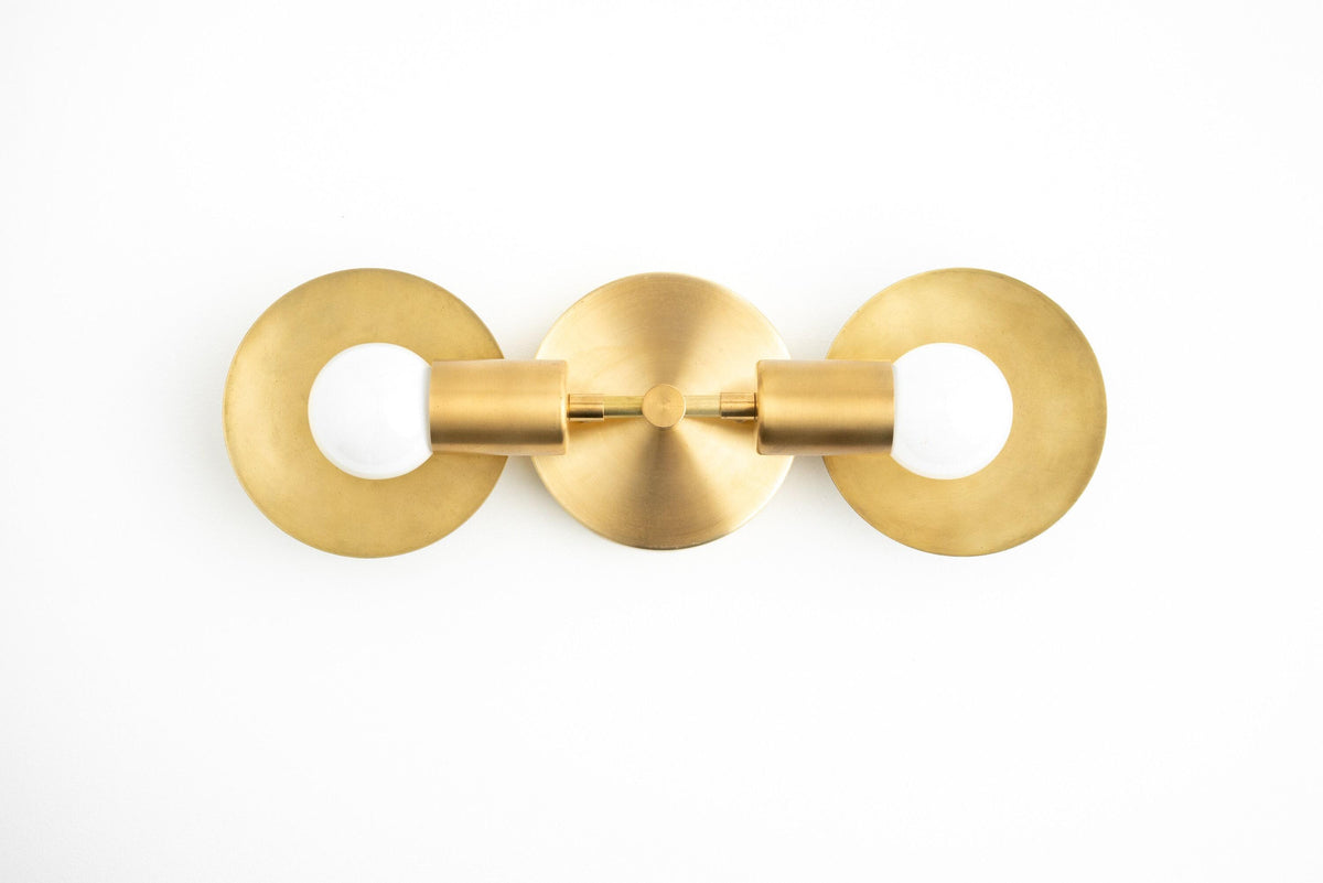 Mid-century modern 2-bulb vanity light in sealed brass with circular backplates and exposed bulbs. - VANITY LIGHT MODEL NO. 2945
