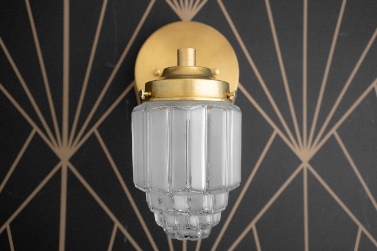 Art Deco style wall sconce with frosted ribbed glass globe and polished brass finish. - SCONCE MODEL NO. 6130