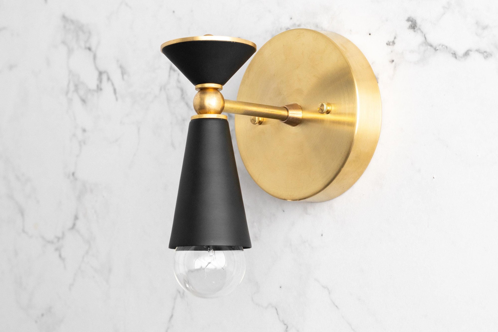Black and brass Art Deco wall sconce with exposed bulb and round backplate. - SCONCE MODEL NO. 8393