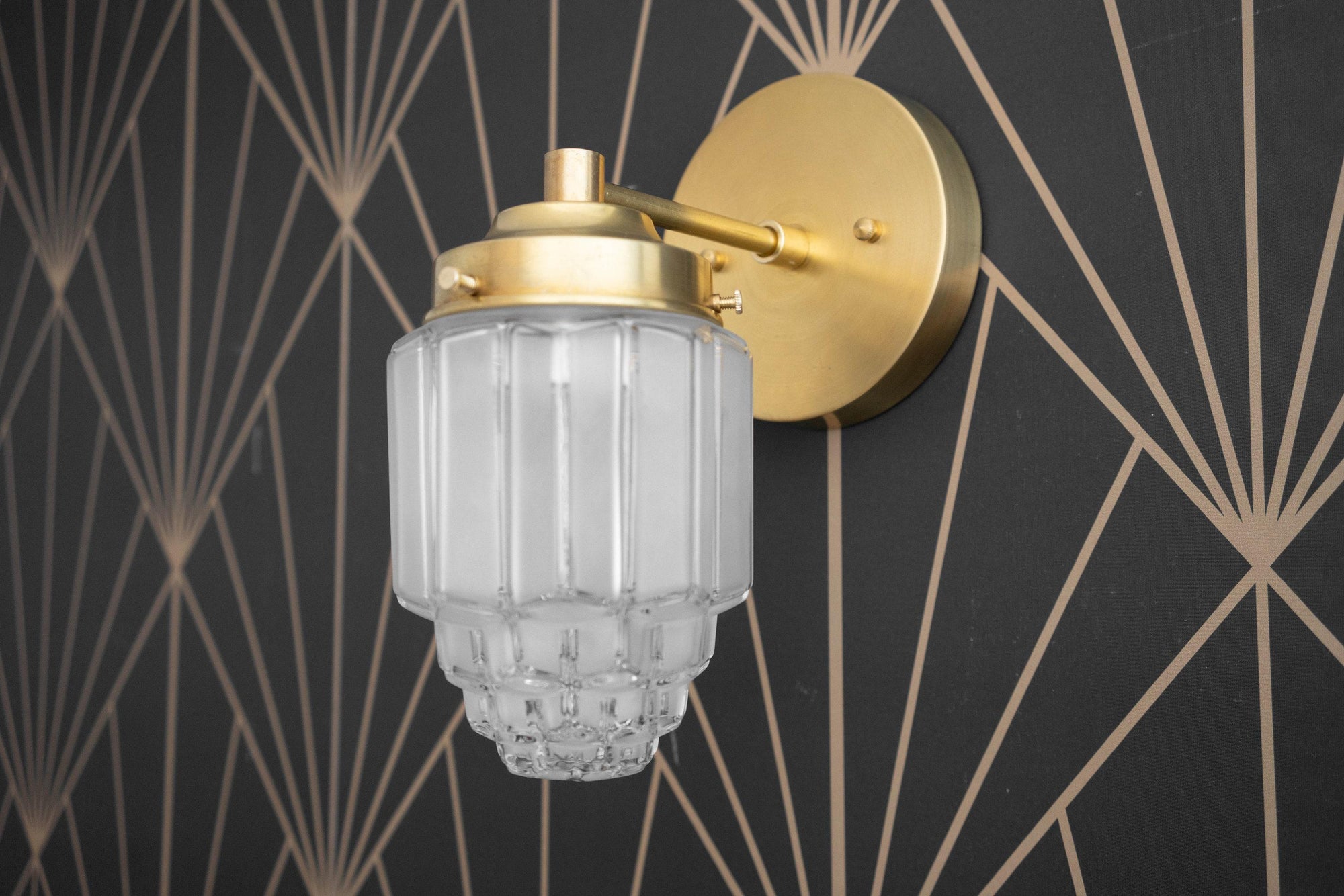 Brushed nickel Art Deco wall sconce with ribbed frosted glass globe and decorative bottom details. - SCONCE MODEL NO. 6130