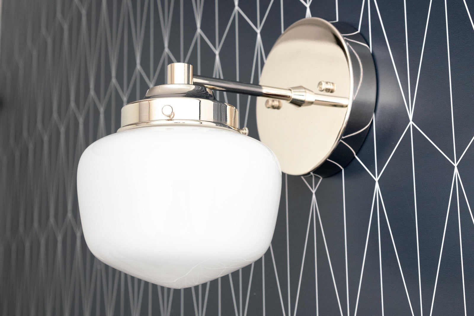 Polished nickel semi-flush sconce with opal glass globe and round wall mount on geometric black wallpaper. - SCONCE MODEL NO. 7321