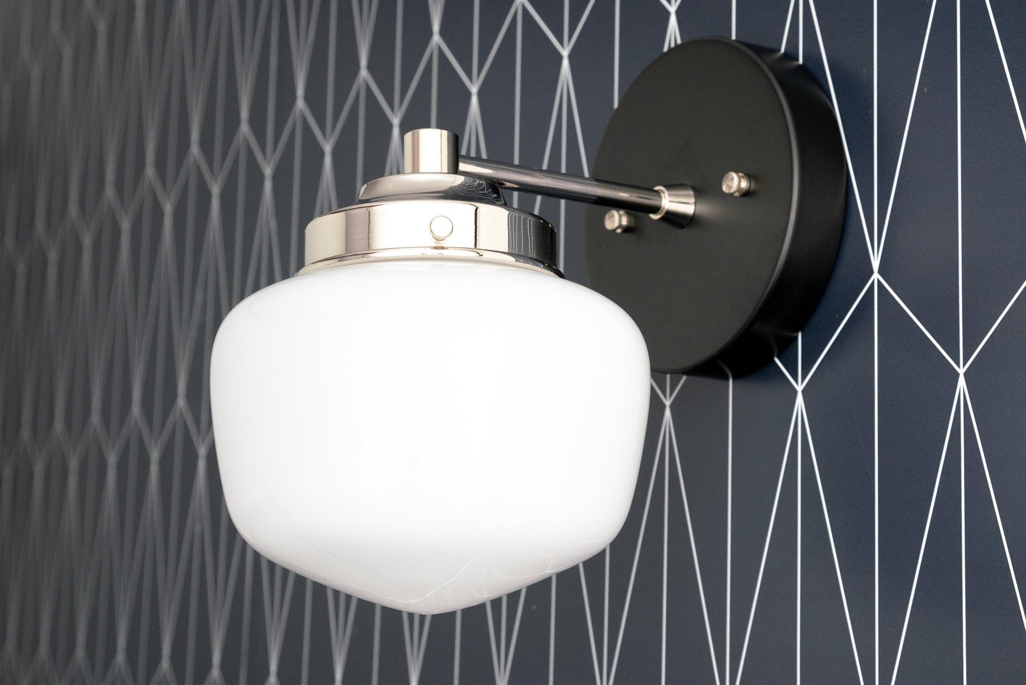 Art Deco wall sconce with white globe shade and polished nickel fixture on geometric dark gray wall. - SCONCE MODEL NO. 7321