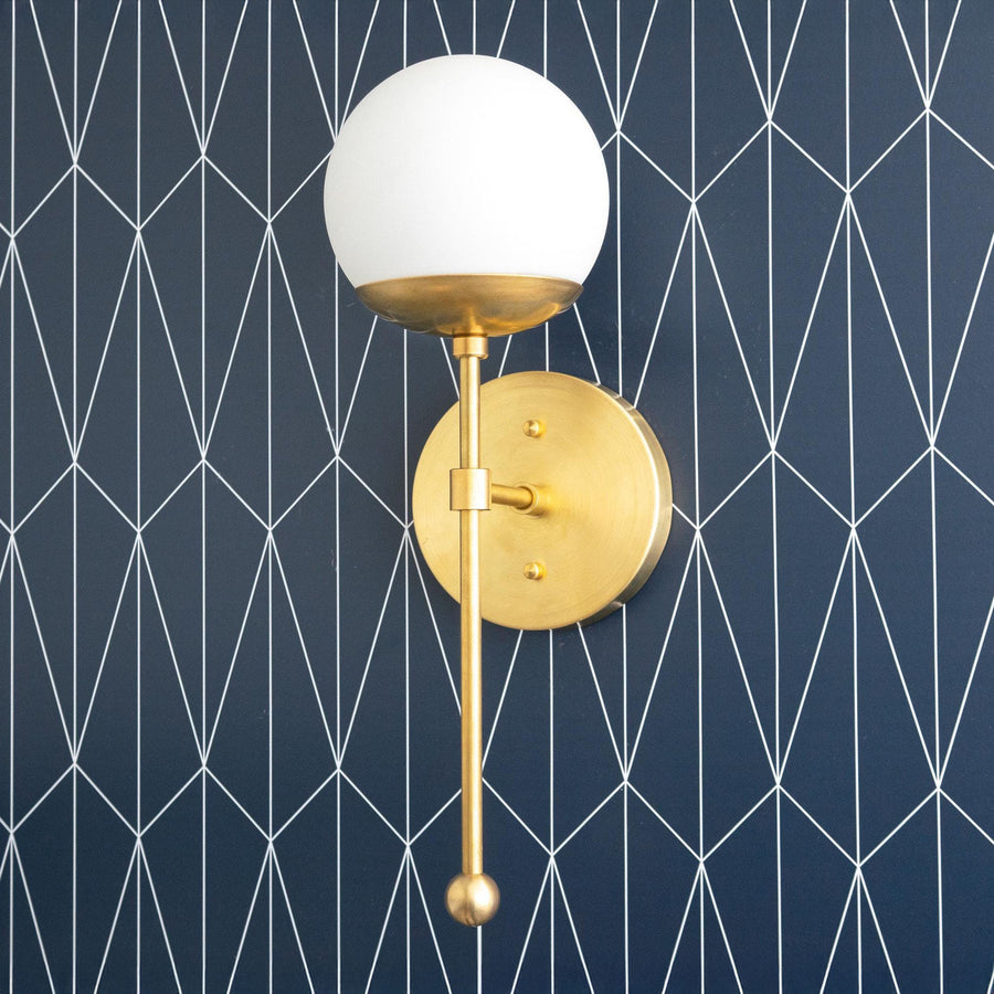 Art Deco semi-flush wall sconce with brass finish and white globe shade on geometric navy wallpaper background. - SCONCE MODEL NO. 1048