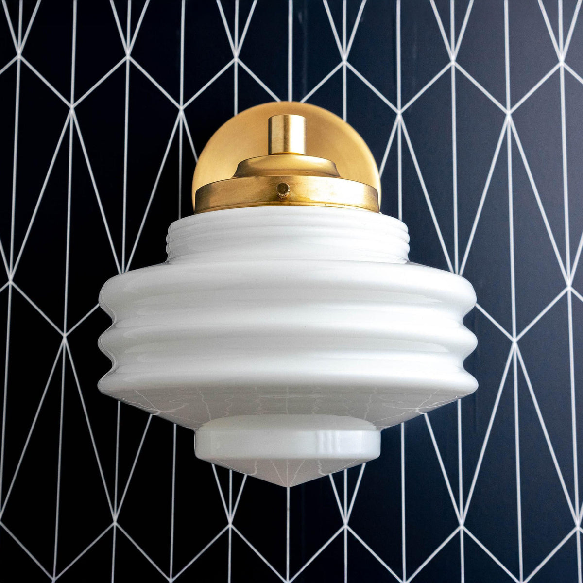 Sconce in Raw or Sealed Brass with a stepped opal glass shade. - SCONCE MODEL NO. 1050