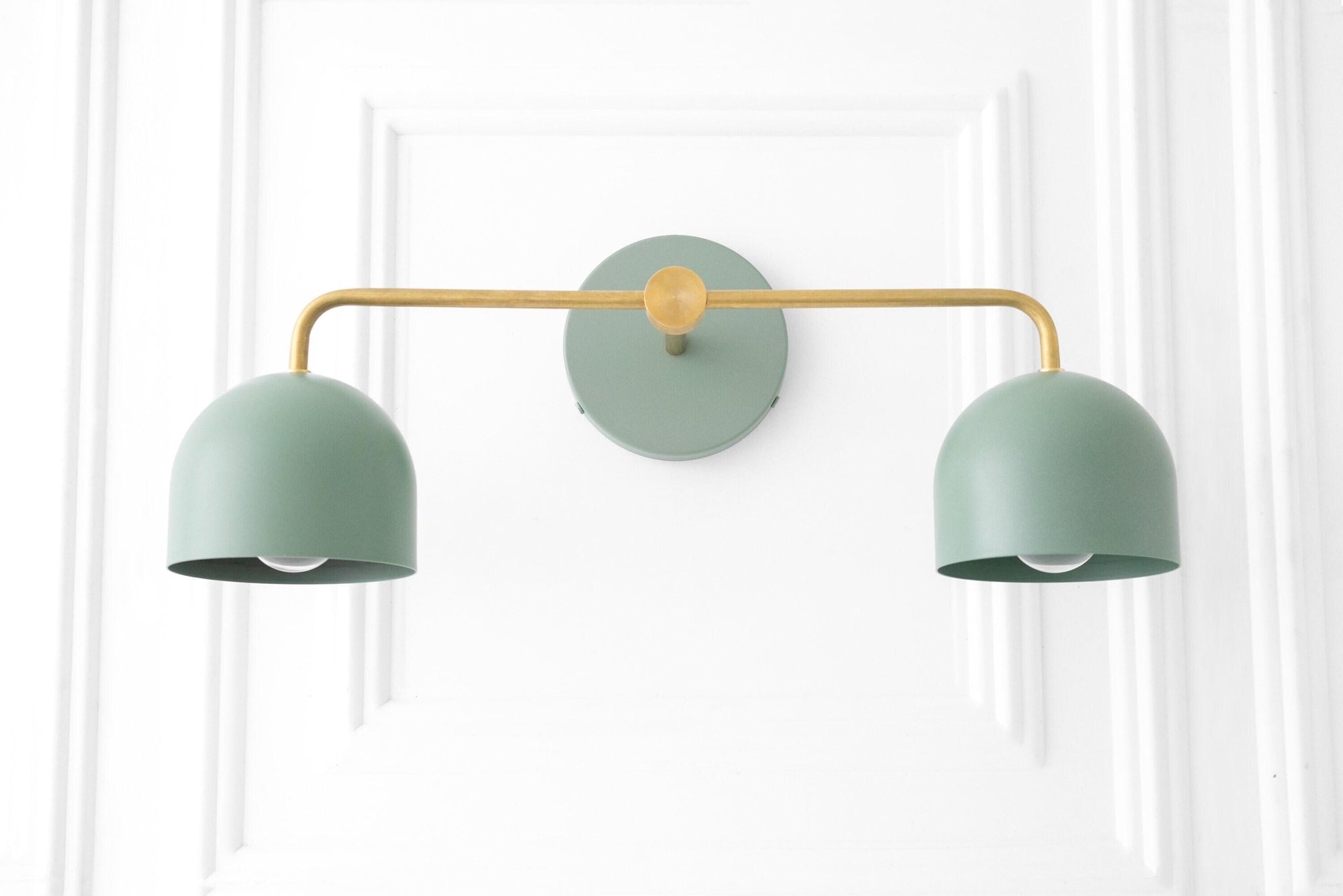Mid-century modern vanity light with two matte green metal shades and a brass-finished horizontal bar. - VANITY LIGHT MODEL NO. 2082