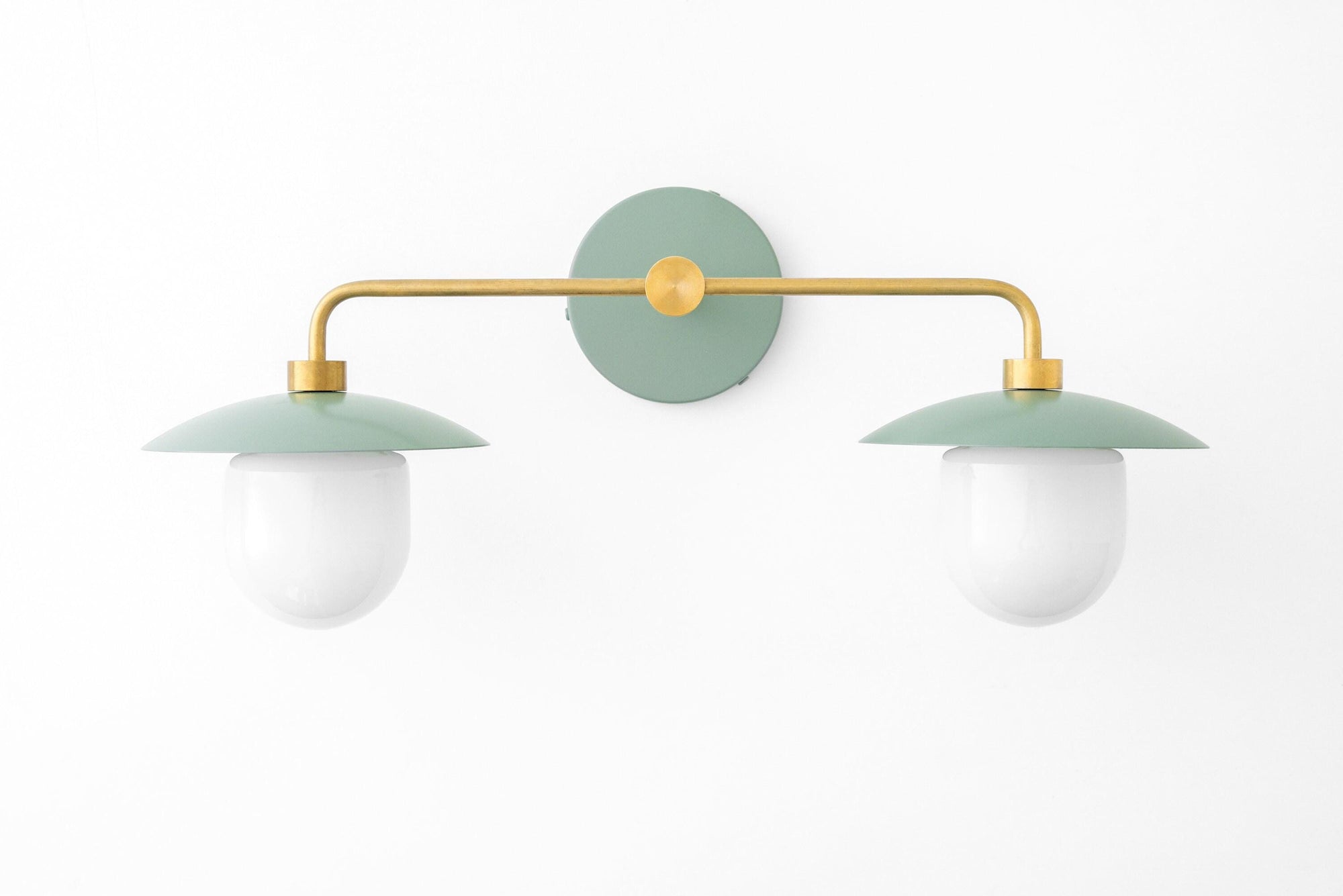 Mid-century modern 2-bulb vanity light with green round shades and brass horizontal arm wall mount. - VANITY LIGHT MODEL NO. 0648