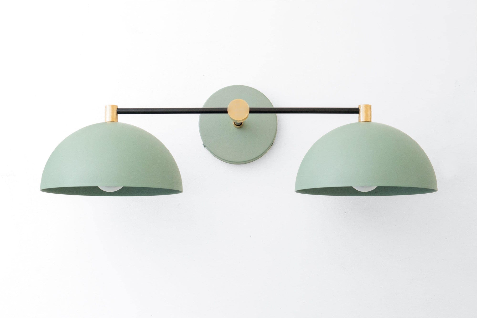 Art Deco style vanity light with two dome-shaped green shades and black raw brass mounting bar. - VANITY LIGHT MODEL NO. 1027