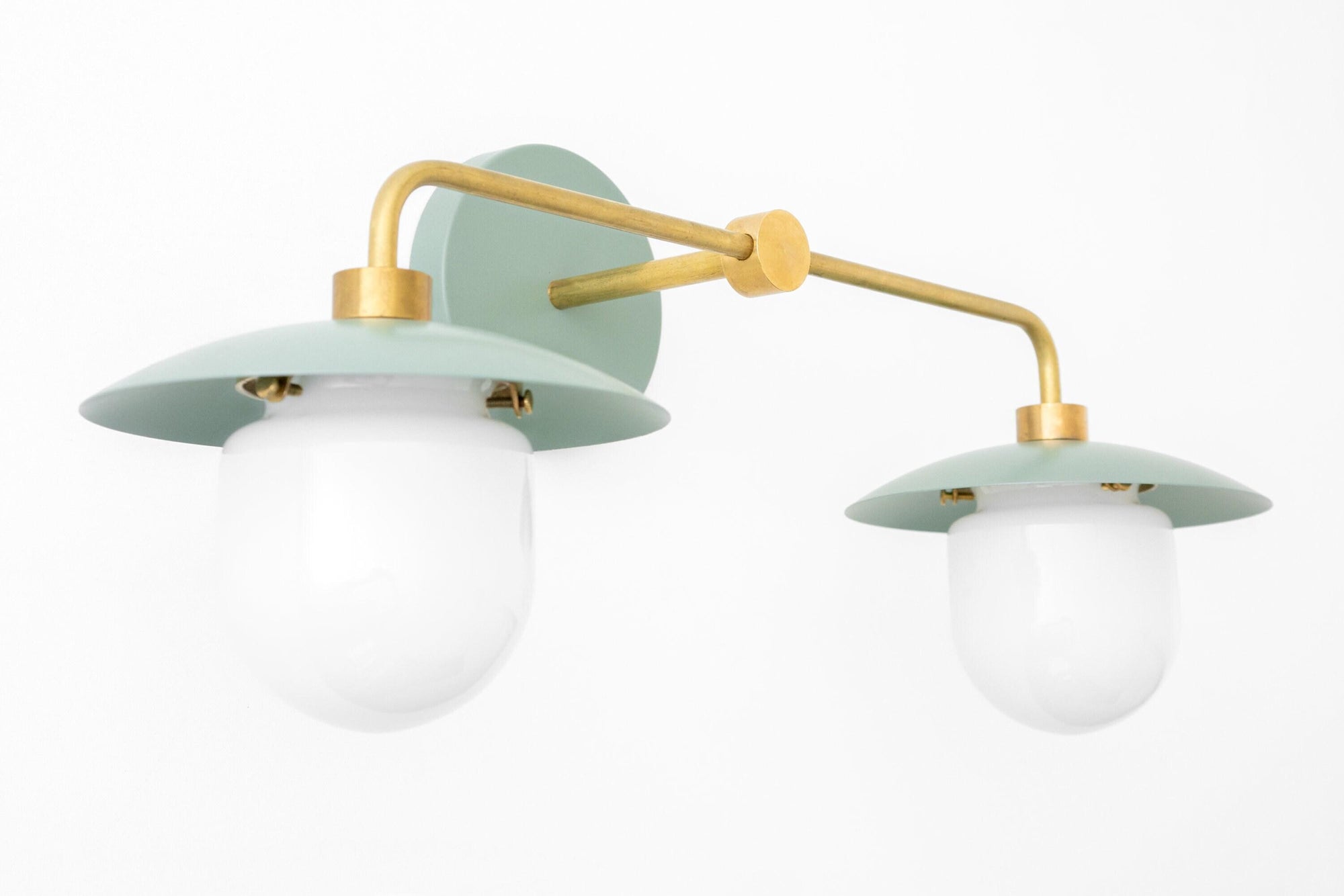 Mid-century modern two-bulb vanity light with green matte shades and brass arms. - VANITY LIGHT MODEL NO. 0648