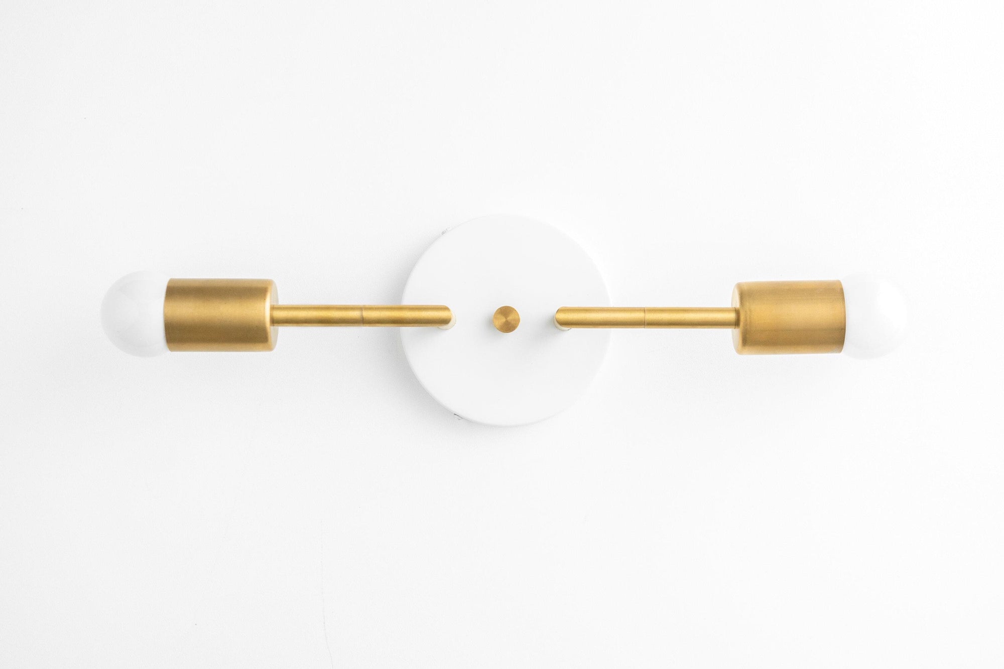 Mid-century modern 2-bulb vanity light in raw brass with white circular backplate and frosted bulbs. - VANITY LIGHT MODEL NO. 1938
