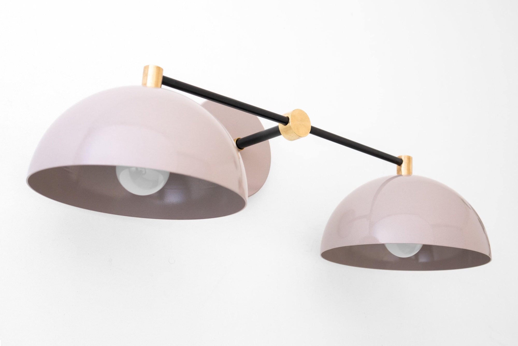 Art Deco double dome vanity light with black rods and raw brass accents in mauve shade. - VANITY LIGHT MODEL NO. 1027