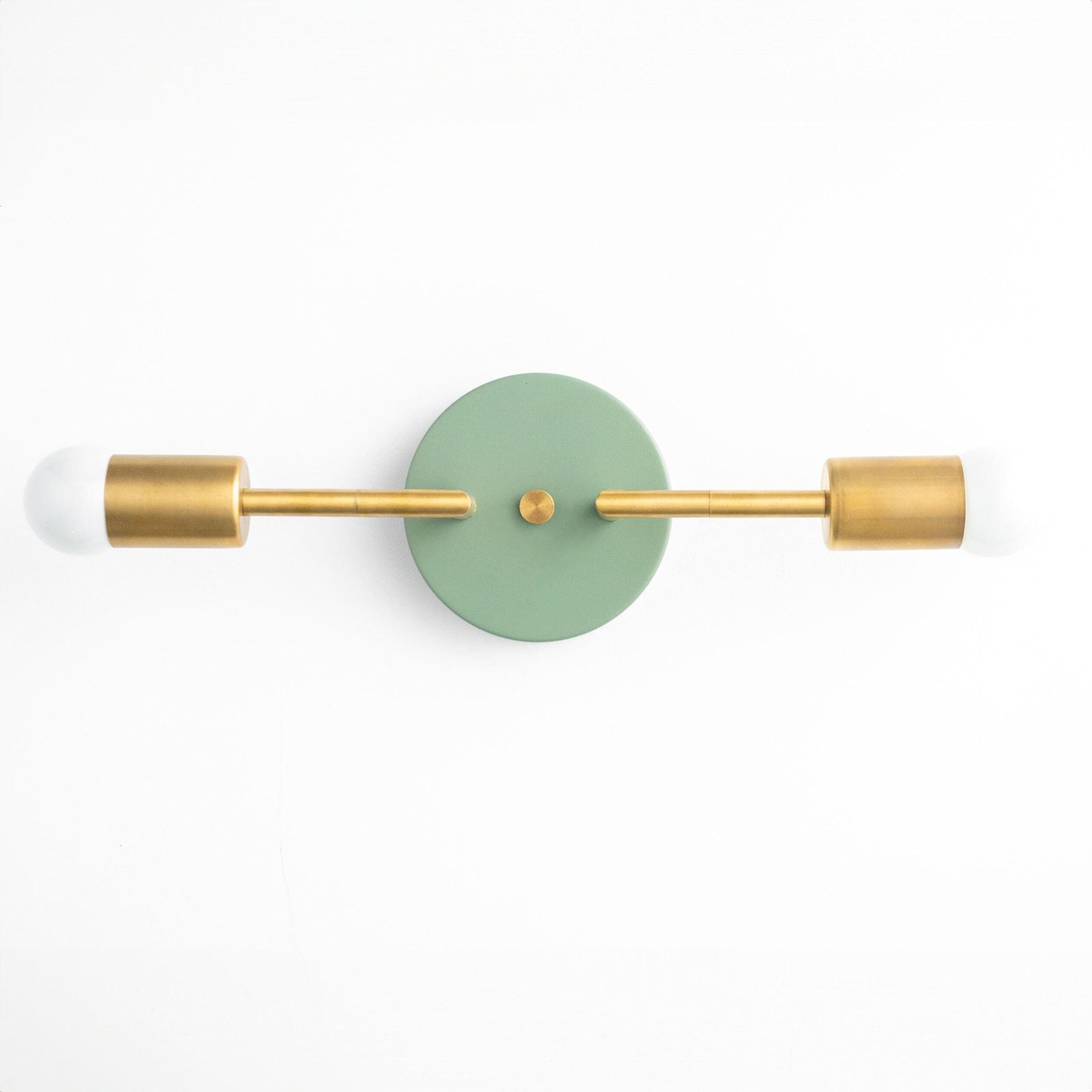 Mid-century modern 2-bulb vanity light with raw brass arms and green circular backplate. - VANITY LIGHT MODEL NO. 1938