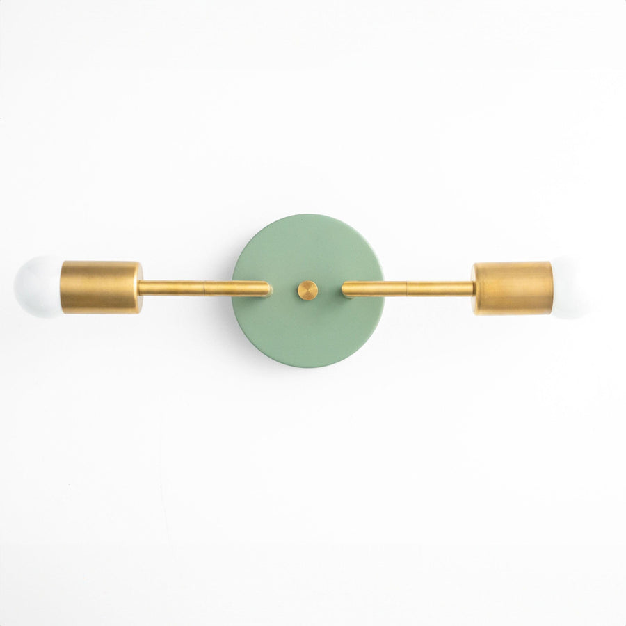 Mid-century modern 2-bulb vanity light with raw brass arms and green circular backplate. - VANITY LIGHT MODEL NO. 1938