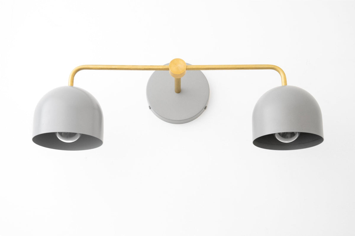 Raw brass vanity light with two smooth matte white dome shades and minimalist design. - VANITY LIGHT MODEL NO. 2082
