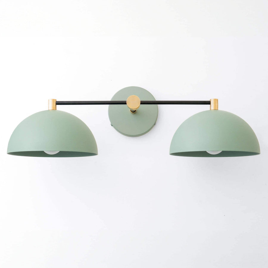 Art Deco vanity light with two matte green dome shades and black and brass metal accents. - VANITY LIGHT MODEL NO. 1027