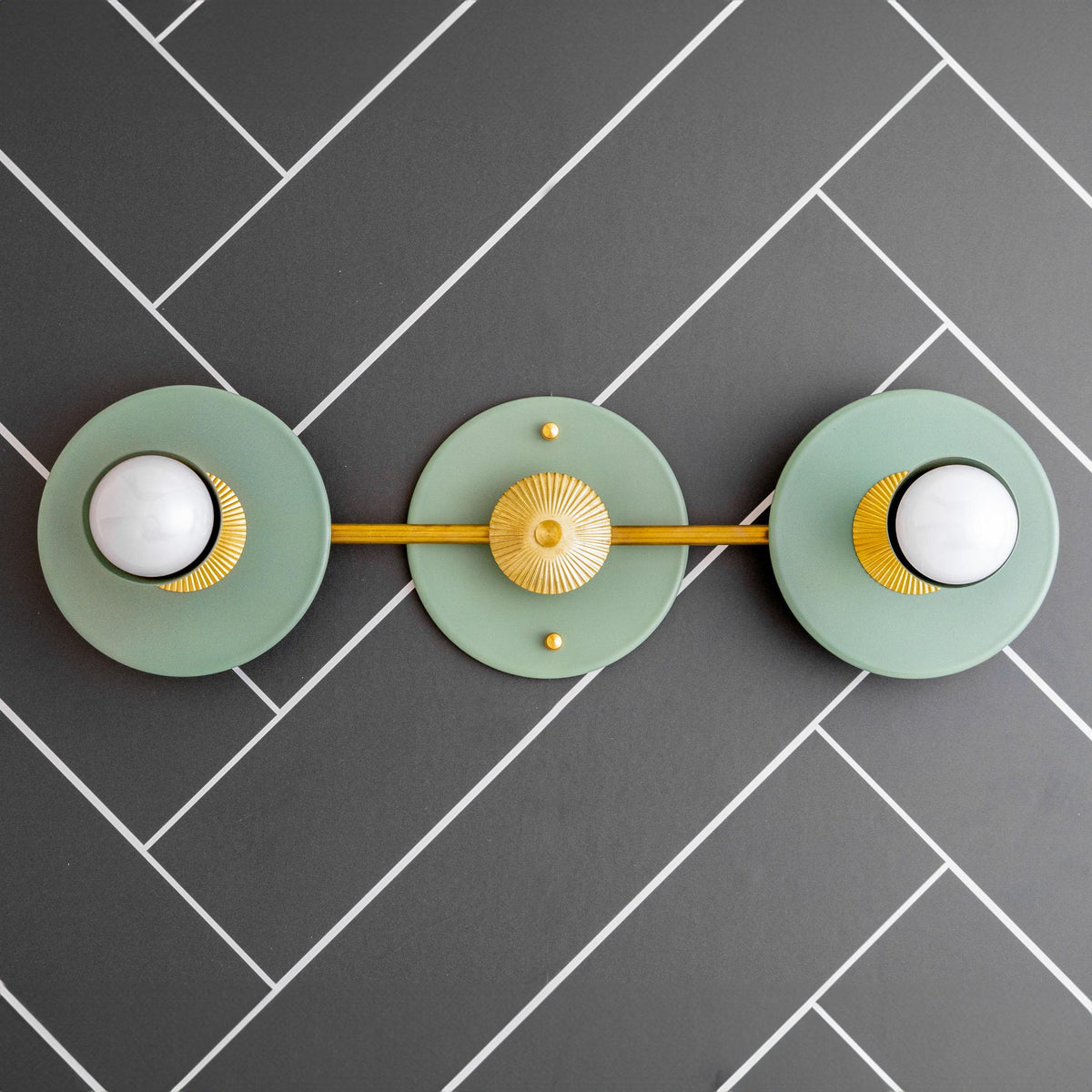 Art Deco 2-bulb vanity light in raw brass with green circular backplates and bare bulbs. - VANITY LIGHT MODEL NO. 4473