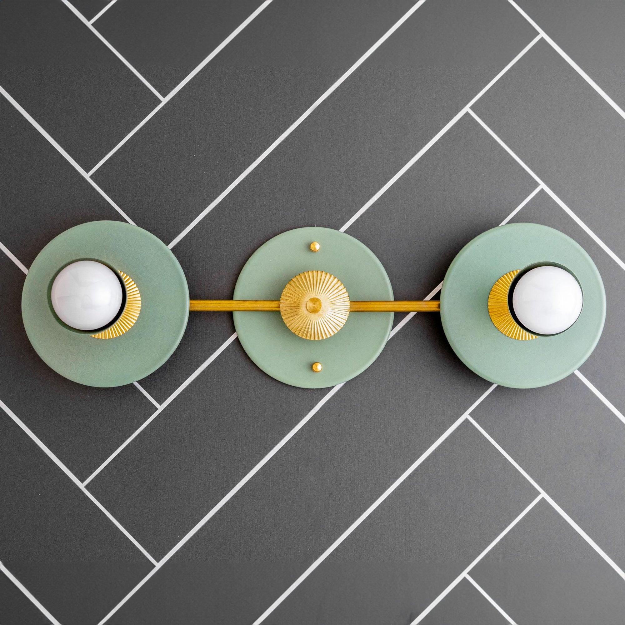 Art Deco 2-bulb vanity light in raw brass with green circular backplates and bare bulbs. - VANITY LIGHT MODEL NO. 4473