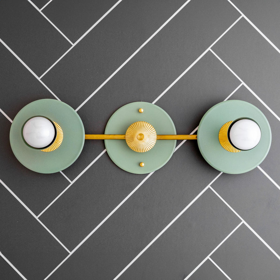 Art Deco 2-bulb vanity light in raw brass with green circular backplates and bare bulbs. - VANITY LIGHT MODEL NO. 4473