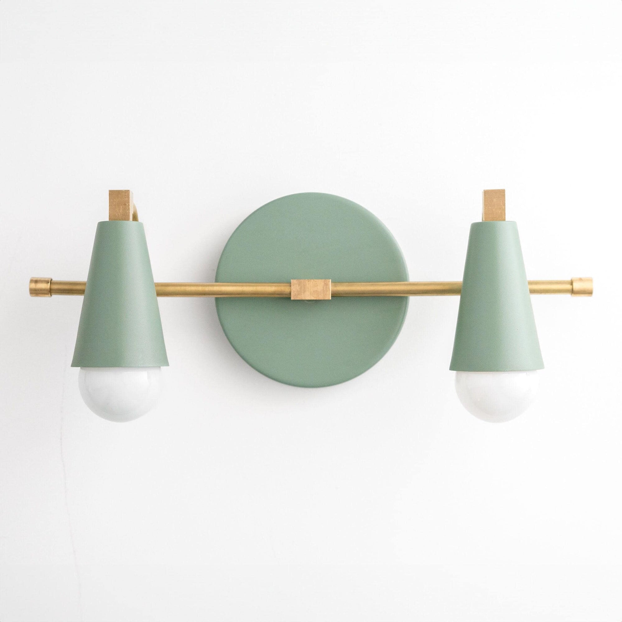 Mid-century modern vanity light with two green conical shades and raw brass horizontal bar and round backplate. - VANITY LIGHT MODEL NO. 1229