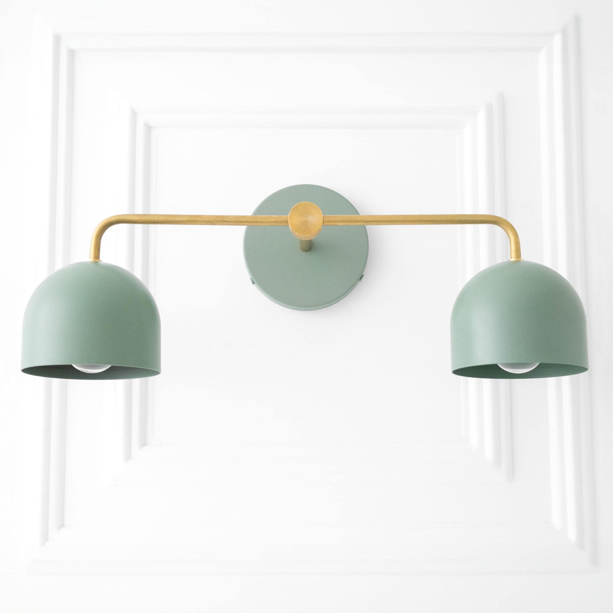 Mid-century modern vanity light with dual matte green dome shades and raw brass horizontal bar mount. - VANITY LIGHT MODEL NO. 2082