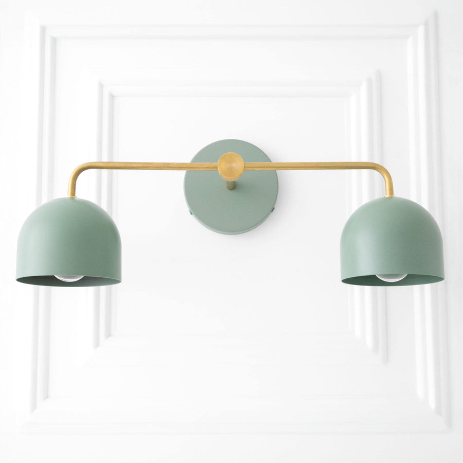 Mid-century modern vanity light with dual matte green dome shades and raw brass horizontal bar mount. - VANITY LIGHT MODEL NO. 2082