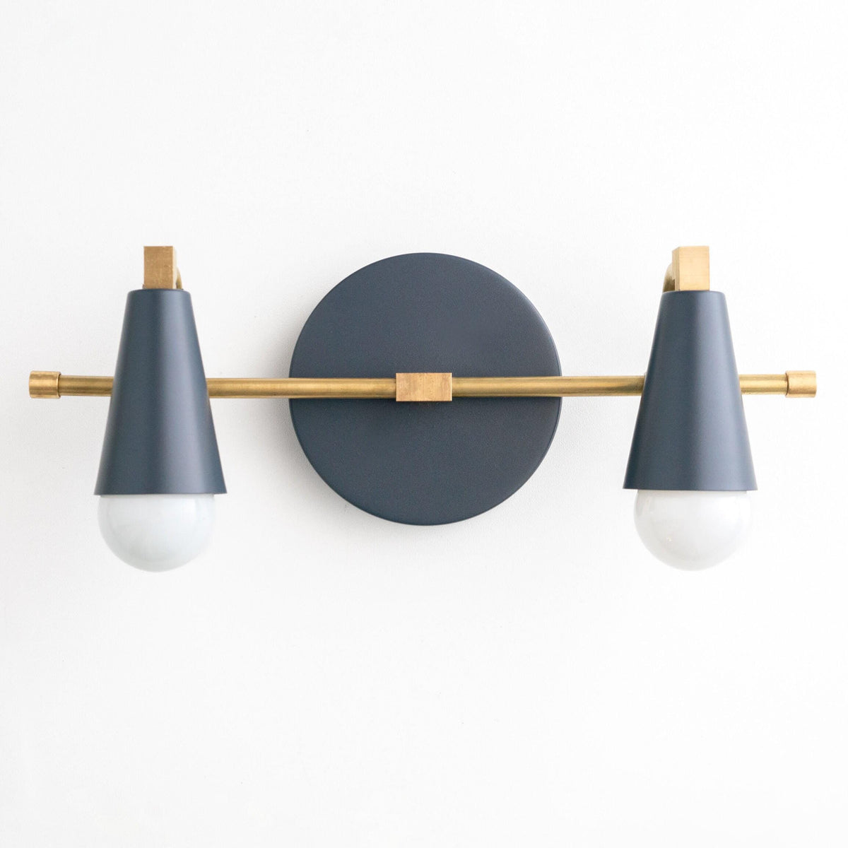 Two-bulb vanity light with raw brass rod and coal blue cone shades on round backplate. - VANITY LIGHT MODEL NO. 1229