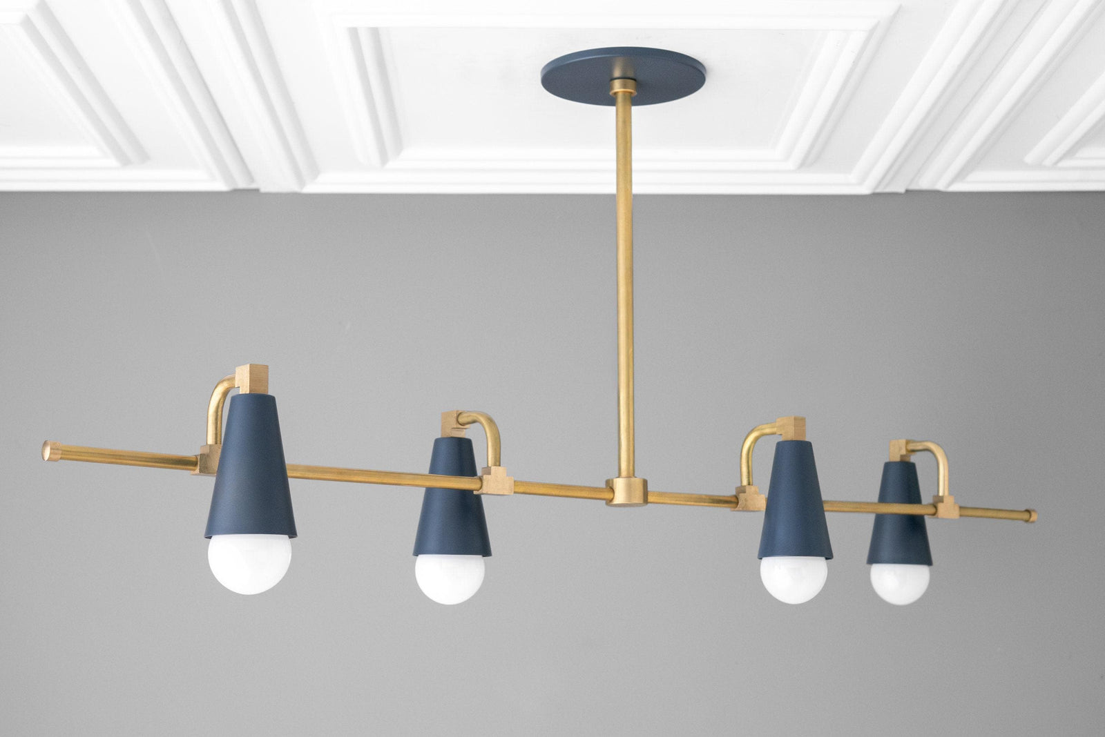 Raw brass chandelier with four coal blue conical shades and exposed bulbs hanging from brass rod. - CHANDELIER MODEL NO. 1239