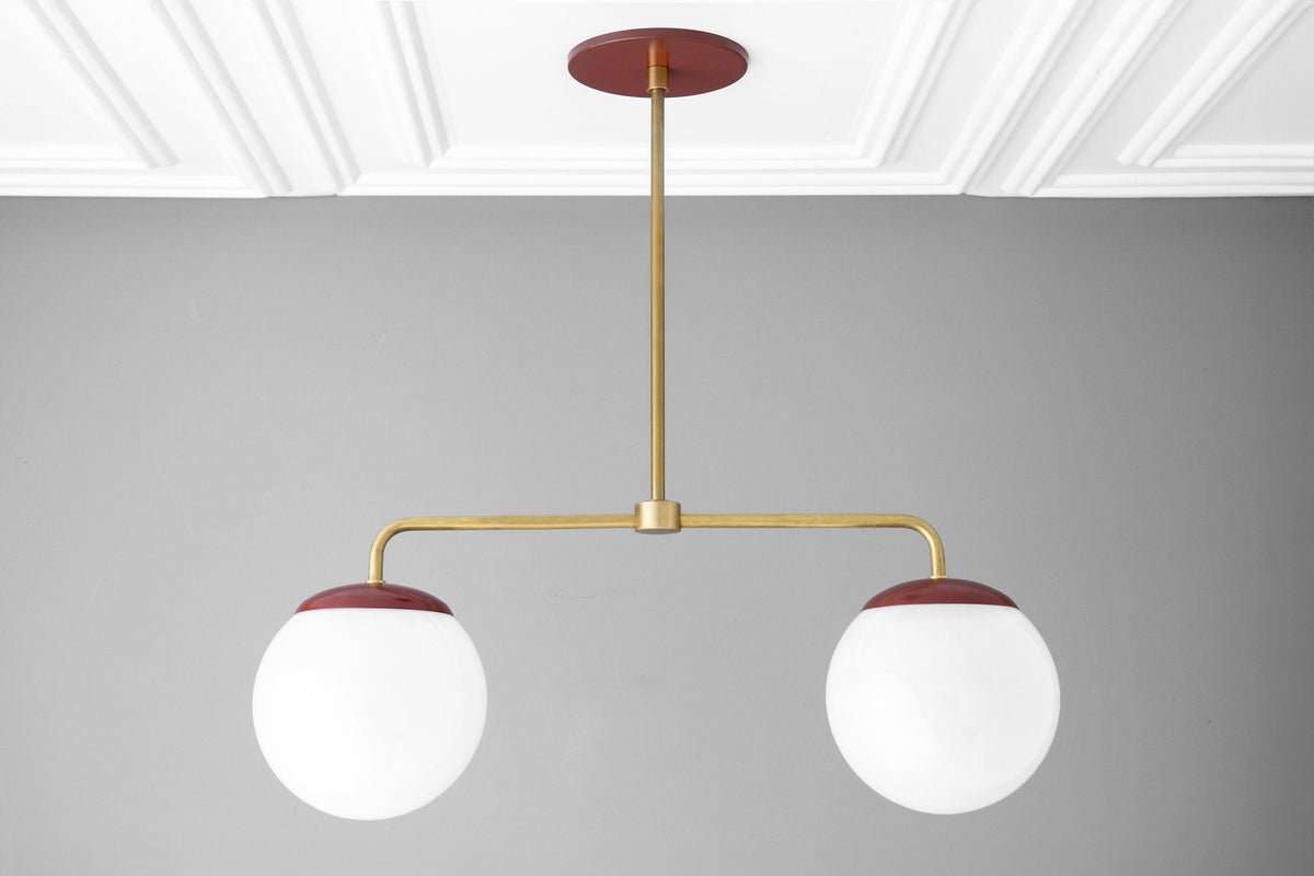 Mid-century modern chandelier with two large white glass globes and raw brass arms with red ceiling mount and globe caps. - CHANDELIER MODEL NO. 3883