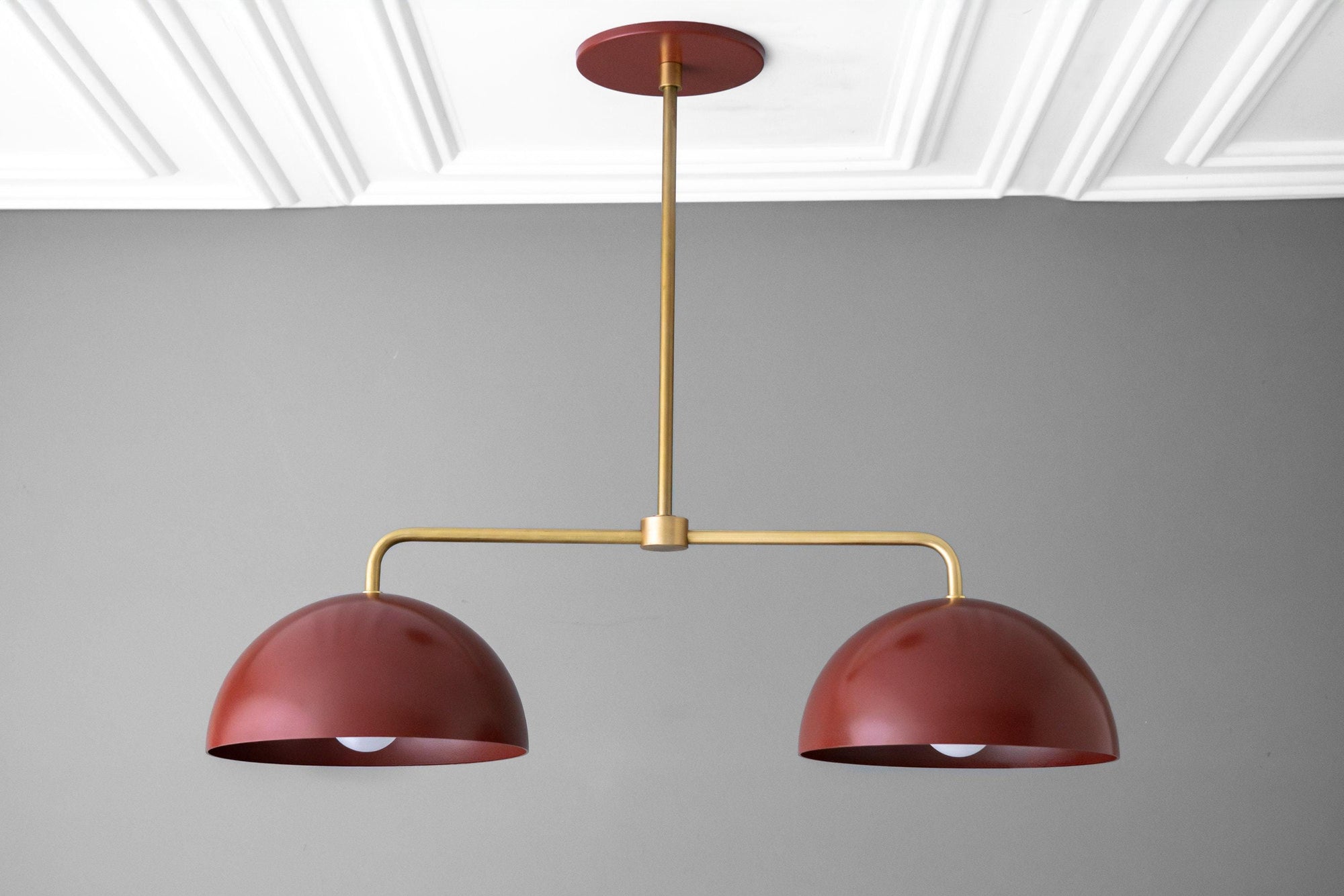 Mid-century modern chandelier with two red dome shades and raw brass horizontal rod suspension. - CHANDELIER MODEL NO. 5391