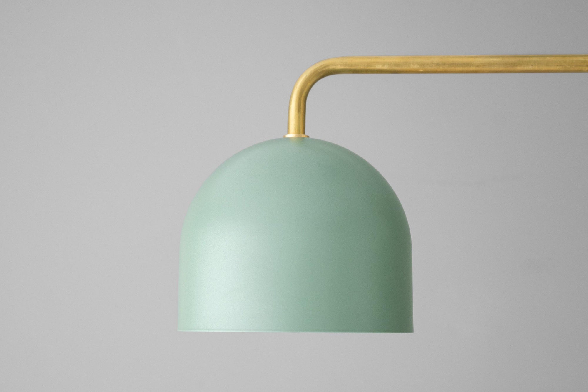 Green metal dome shade chandelier with curved brass arm against gray background. - CHANDELIER MODEL NO. 5719