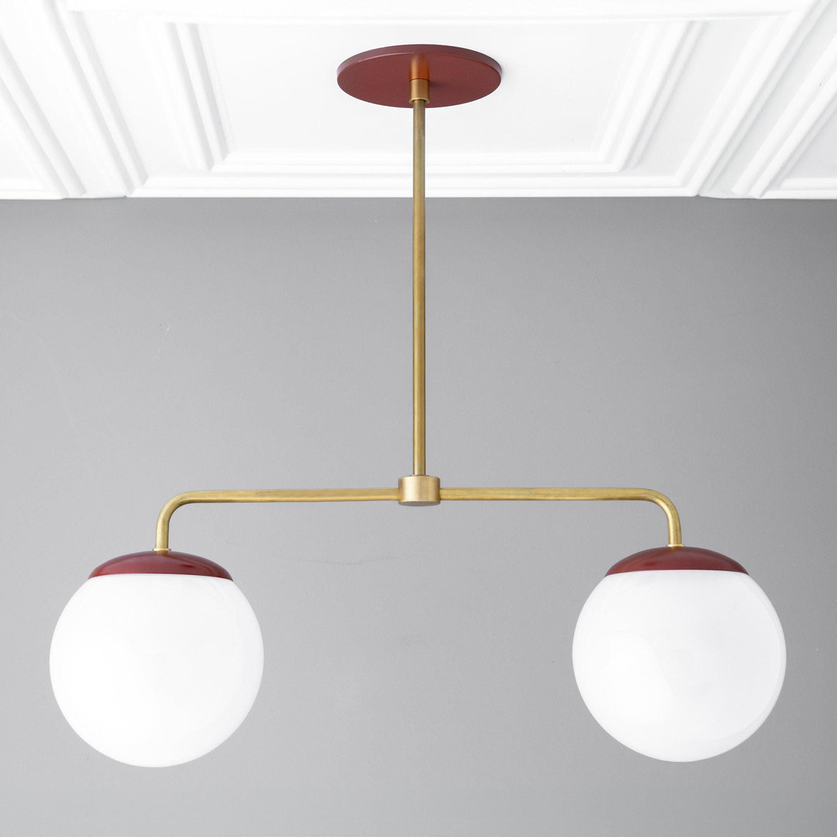 Mid-century modern chandelier with two large white glass globes and red raw brass accents. - CHANDELIER MODEL NO. 3883