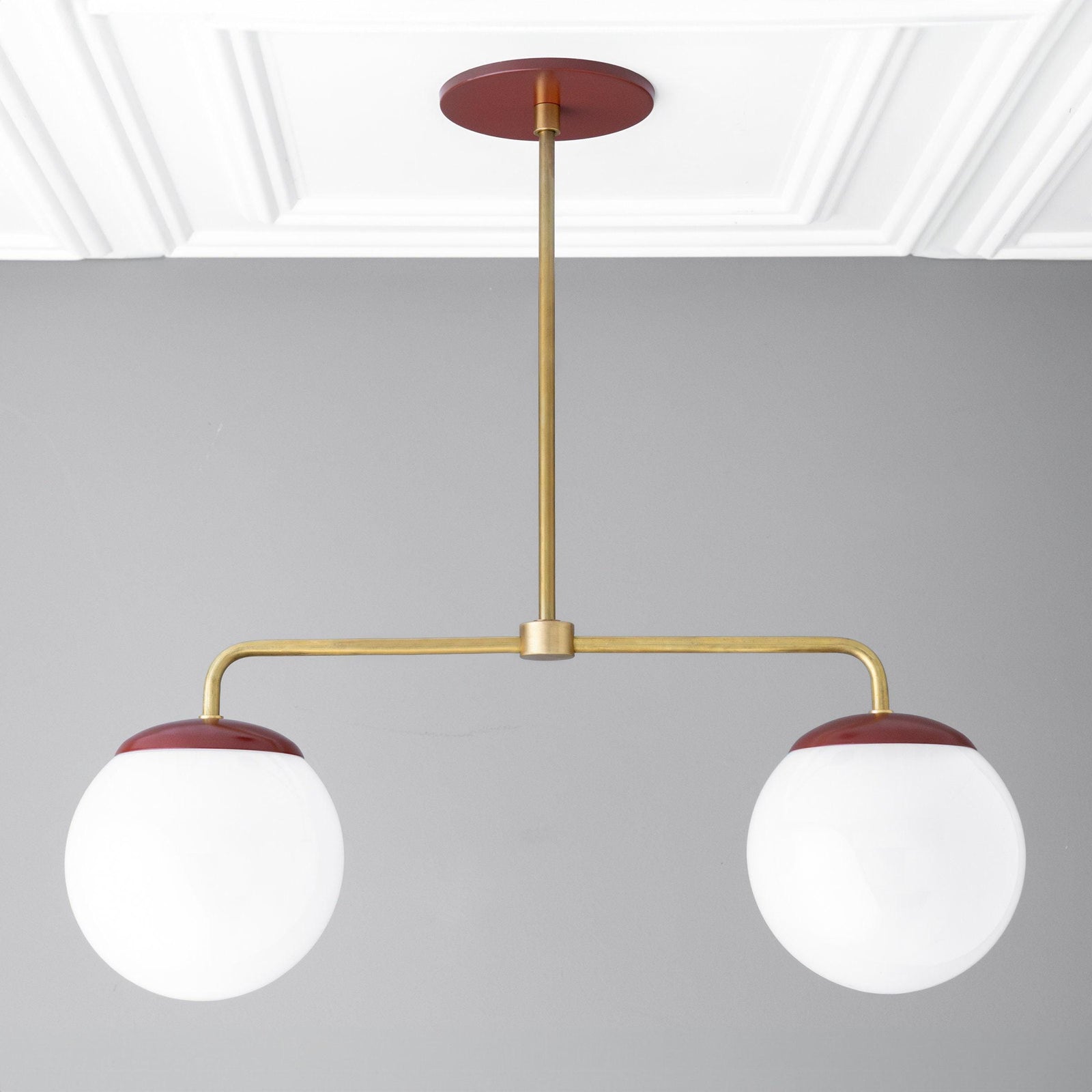 Mid-century modern chandelier with two large white glass globes and red raw brass accents. - CHANDELIER MODEL NO. 3883