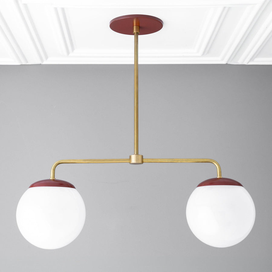 Mid-century modern chandelier with two large white glass globes and red raw brass accents. - CHANDELIER MODEL NO. 3883