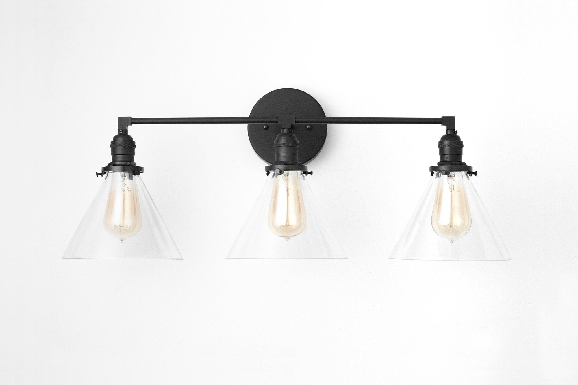 Three-bulb black vanity light with clear glass triangle shades and exposed filament bulbs. - VANITY LIGHT MODEL NO. 5219