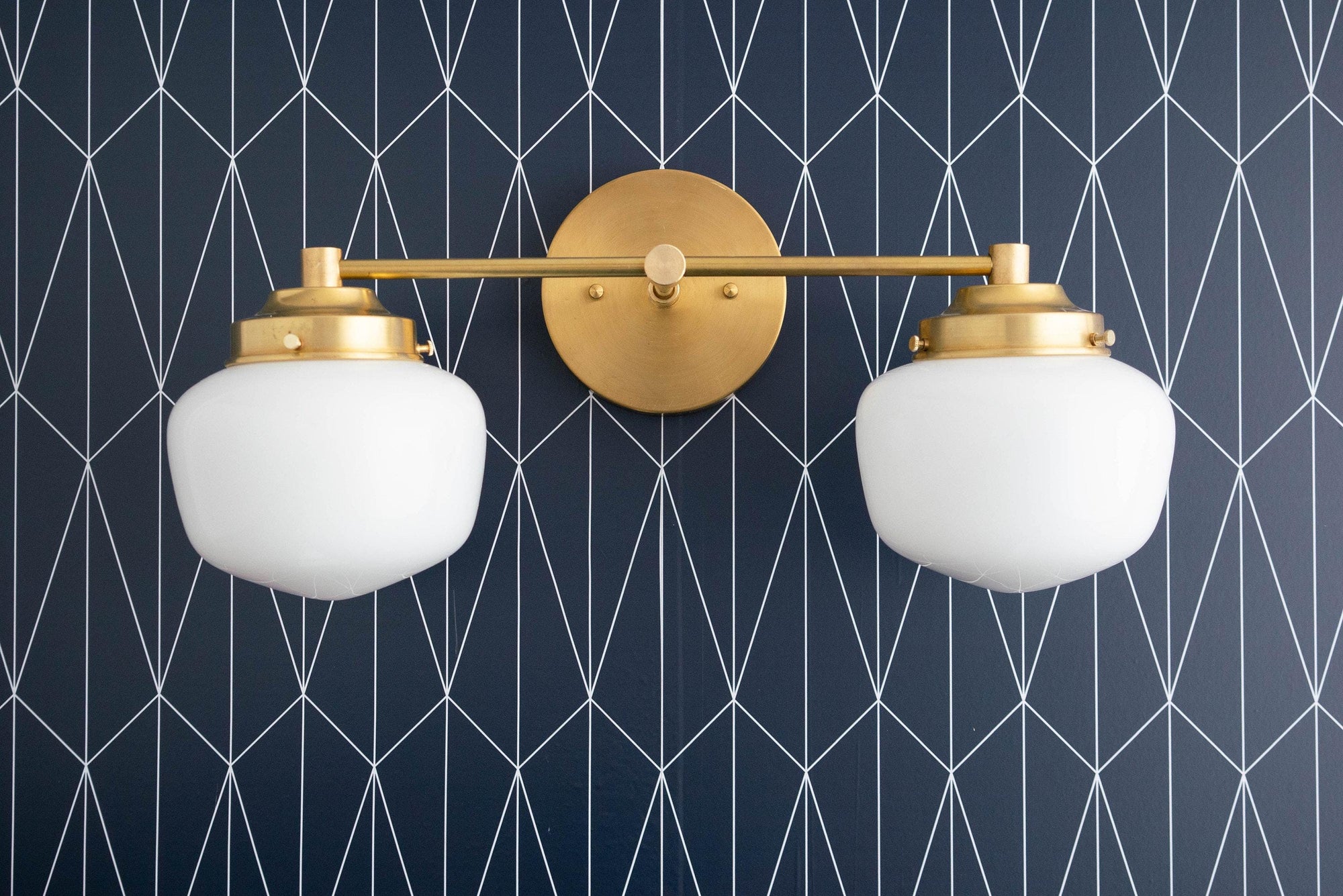 Mid-century modern double globe vanity light in raw brass finish with white glass shades. - VANITY LIGHT MODEL NO. 5799