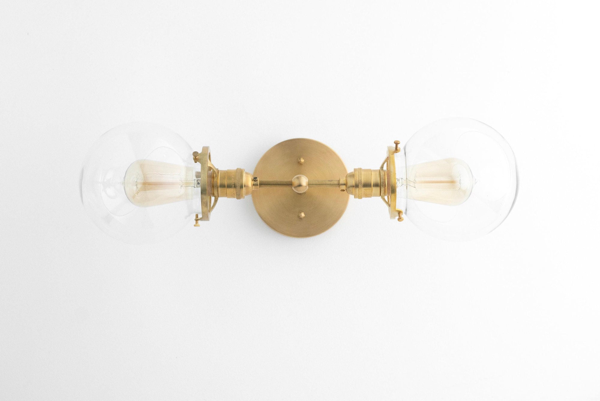 Mid-century modern two-bulb vanity light with clear globe bulbs and raw brass finish. - VANITY LIGHT MODEL NO. 7350