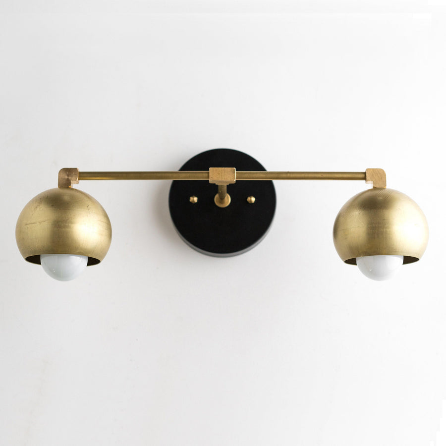Mid-century modern vanity light with two raw brass dome shades and black circular wall mount. - VANITY LIGHT MODEL NO. 5469