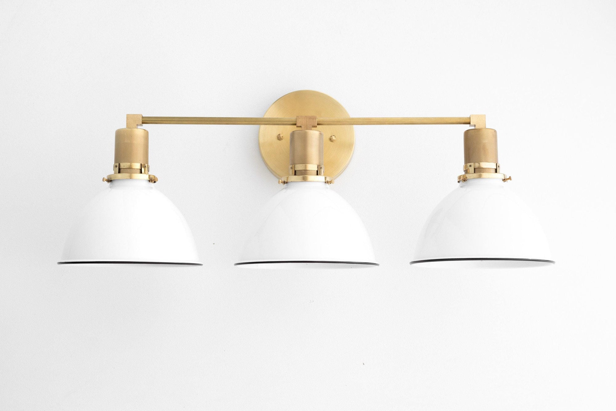 Mid-century modern 3-bulb vanity light with white metal shades and raw brass finish. - VANITY LIGHT MODEL NO. 2439