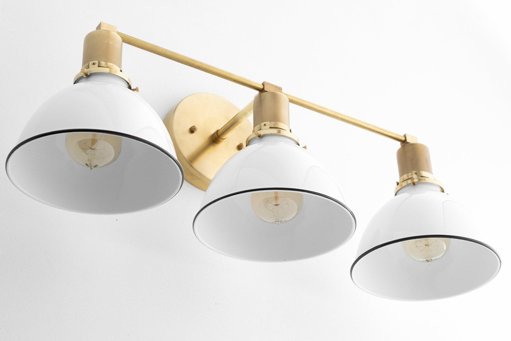 Mid-century modern 3-bulb vanity light with white metal shades and raw brass accents. - VANITY LIGHT MODEL NO. 2439