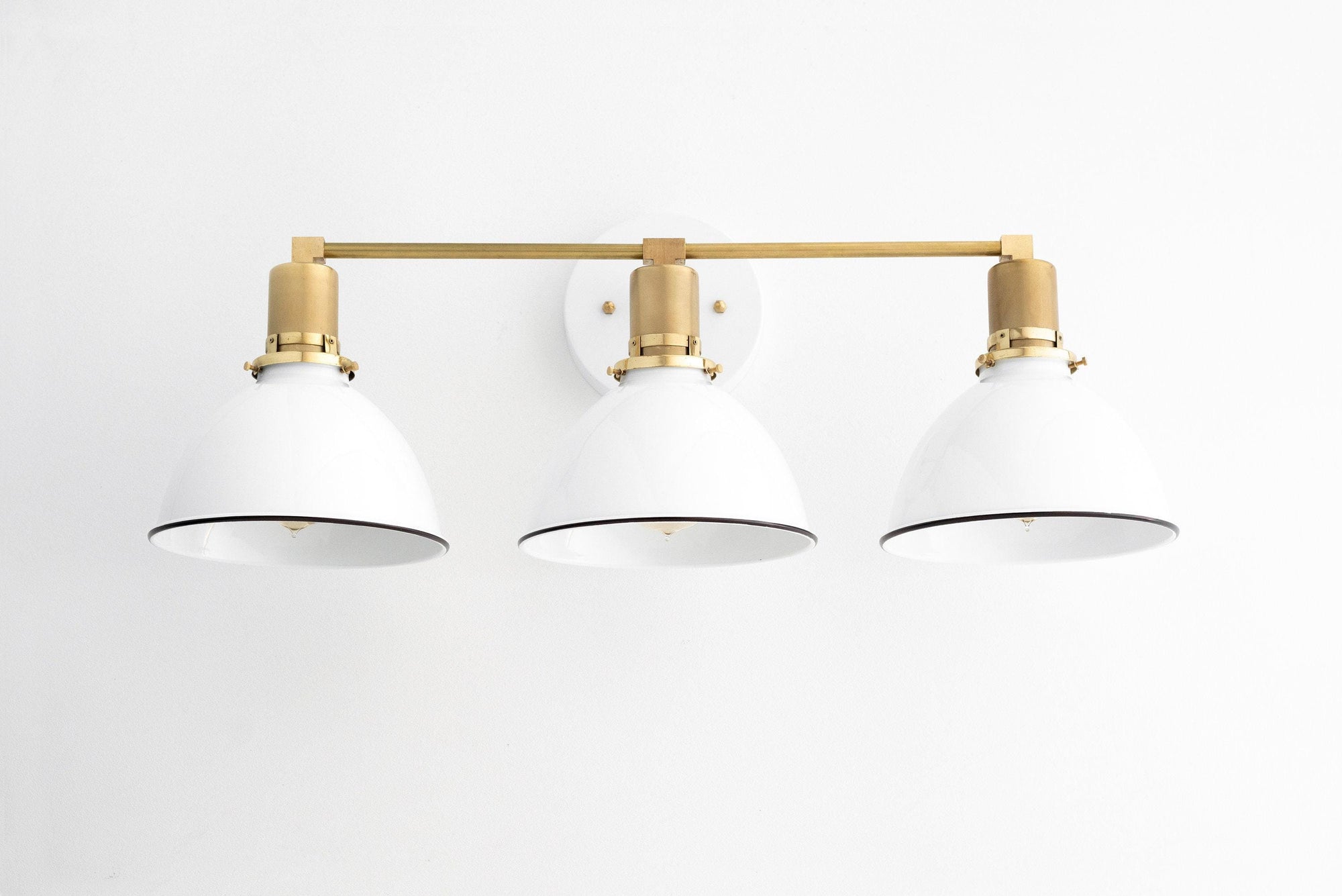 Mid-century modern 3-bulb vanity light with white shades and raw brass fixtures. - VANITY LIGHT MODEL NO. 2439