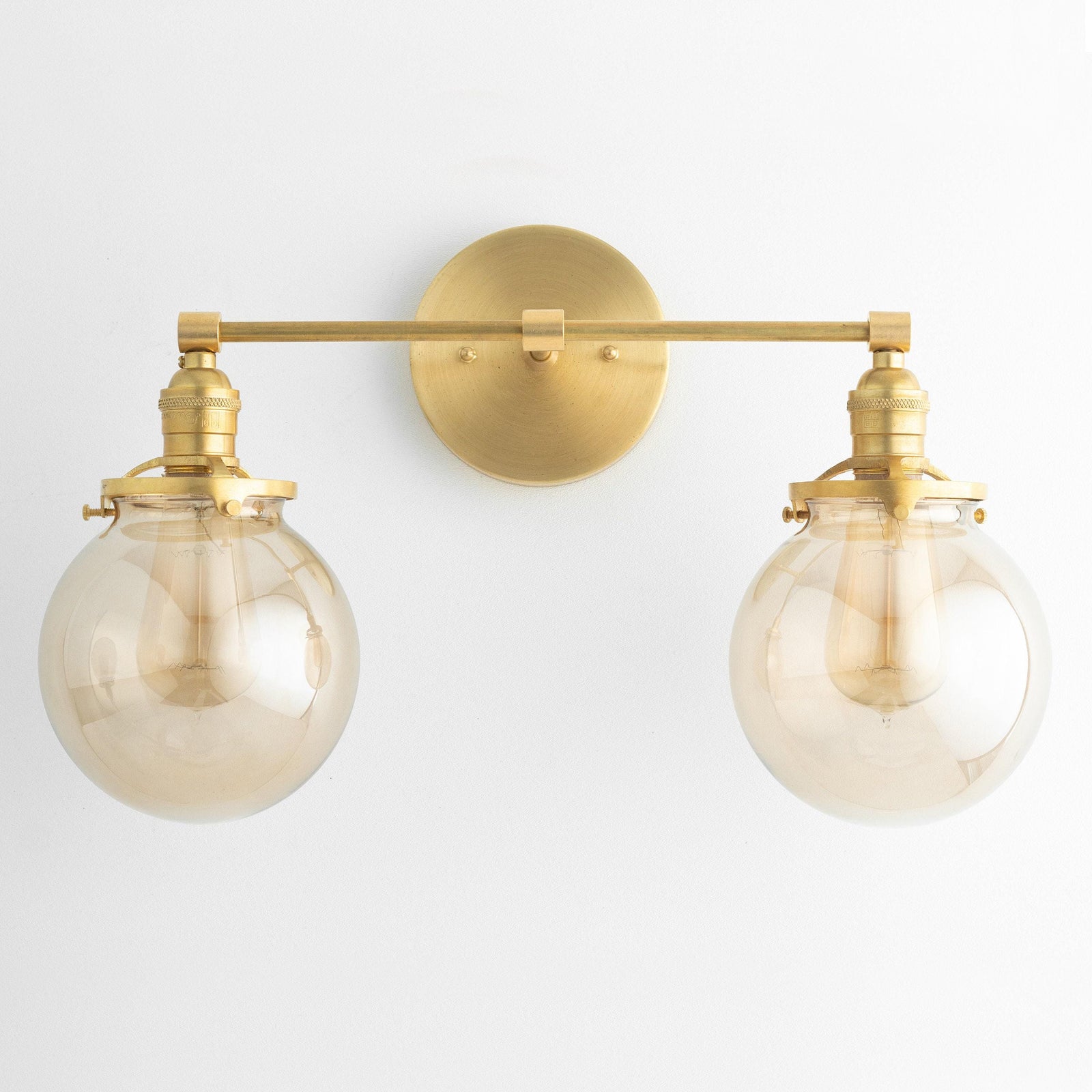 Mid-century modern double globe vanity light in raw brass with clear glass shades. - VANITY LIGHT MODEL NO. 4270