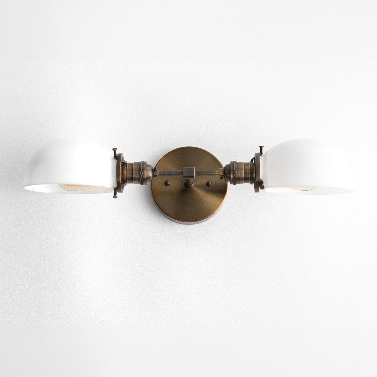Mid-century modern two-bulb vanity light with antique brass finish and white glass shades. - VANITY LIGHT MODEL NO. 1734