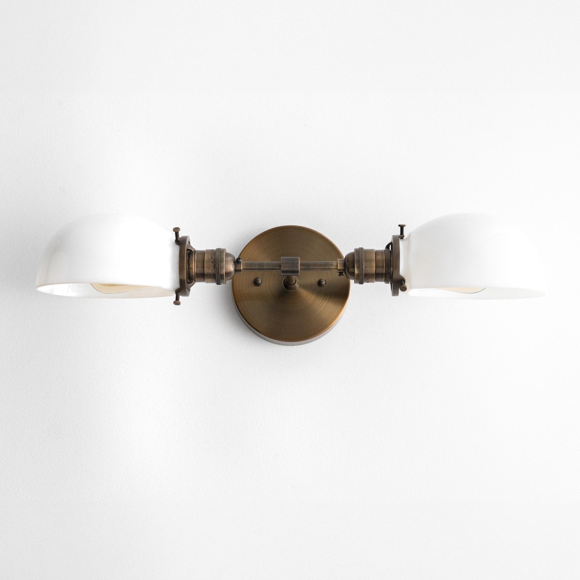 Mid-century modern two-bulb vanity light with antique brass finish and white glass shades. - VANITY LIGHT MODEL NO. 1734