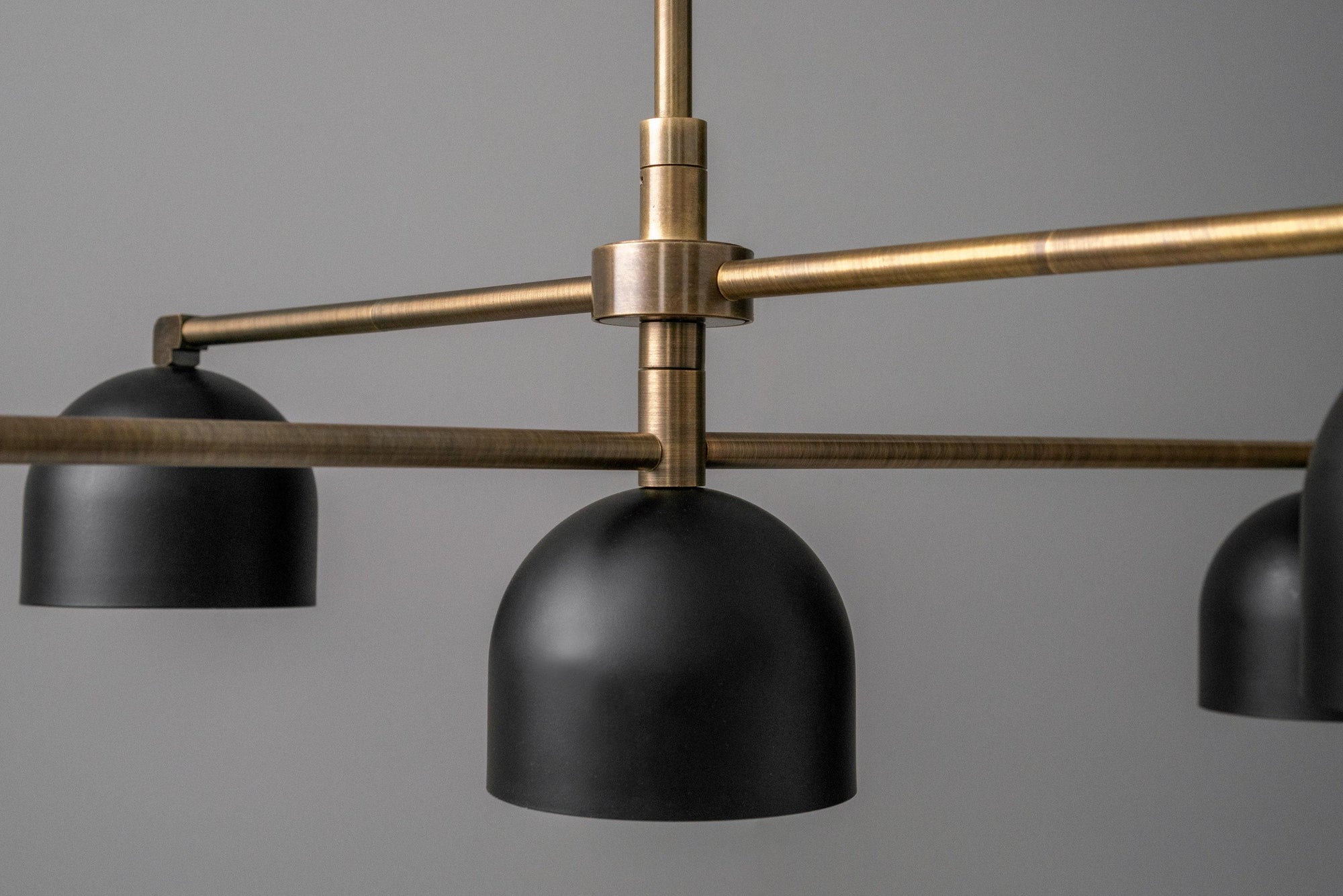 Mid-century modern chandelier with matte black dome shades and antique brass arms. - CHANDELIER MODEL NO. 4267
