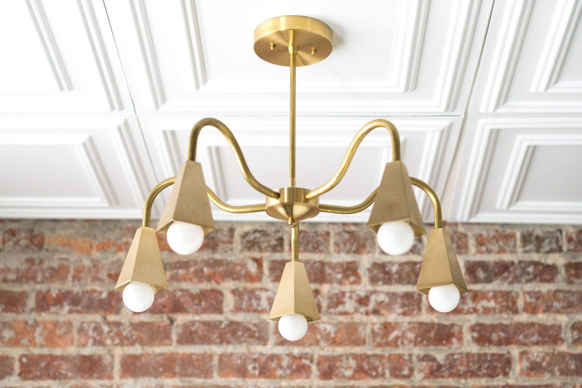 Mid-century modern raw brass chandelier with five cone-shaped bare bulb holders and curved arms. - CHANDELIER MODEL NO. 2464